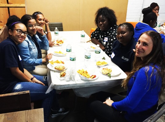 St. Hope students enjoying some delicious Shake Shack at a long white table