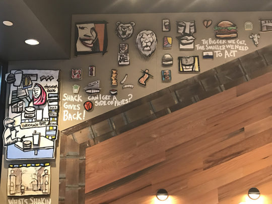 Secondary view of Artist Leon Johnson's array of work on the Morningside Heights Shack wall