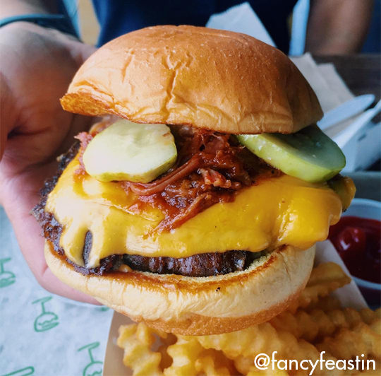 Roker Burger held in hand being presented