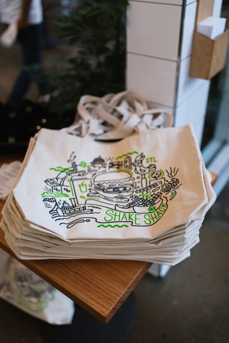 A stack of Shake Shack tote bags