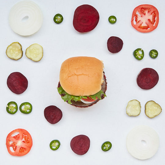 Veggie Shack from above with toppings laid out aside it