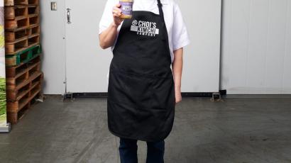 Choi Kimchee representative holding a jar of kimchee